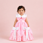 Pink floor-length gown for girls with white satin bow accents and layered organza skirt — Fairy Frills handcrafted princess dress
