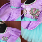 Collage of a purple and teal dress with decorative elements on a wooden surface.